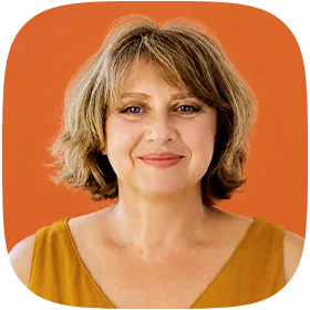 A smiling woman in her early 60s