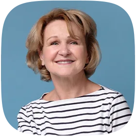 A smiling woman in her late 50s