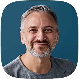 A smiling man in his early 50s